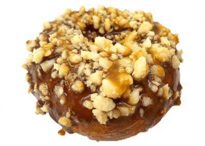 Chocolate glazed donut topped with macadamia nuts and caramel drizzle from Purvé Donut Stop Hawaii