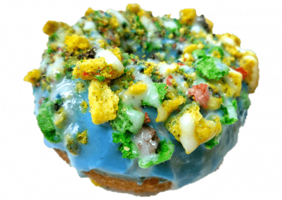 Blue mixed berry glazed donut topped with captain crunch berries and cream cheese drizzle from Purvé Donut Stop Hawaii